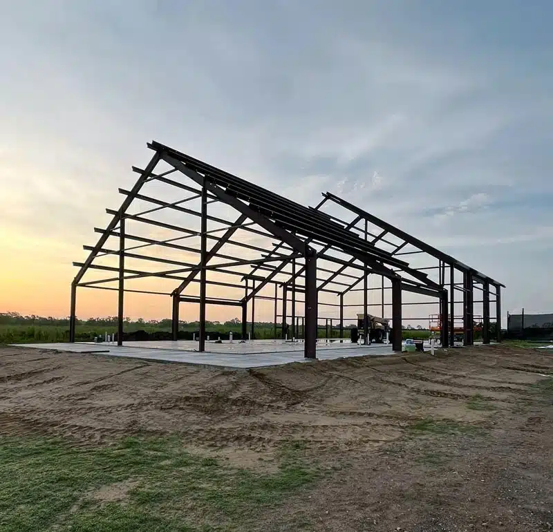 Barndominium frame at sunset in Arkansas